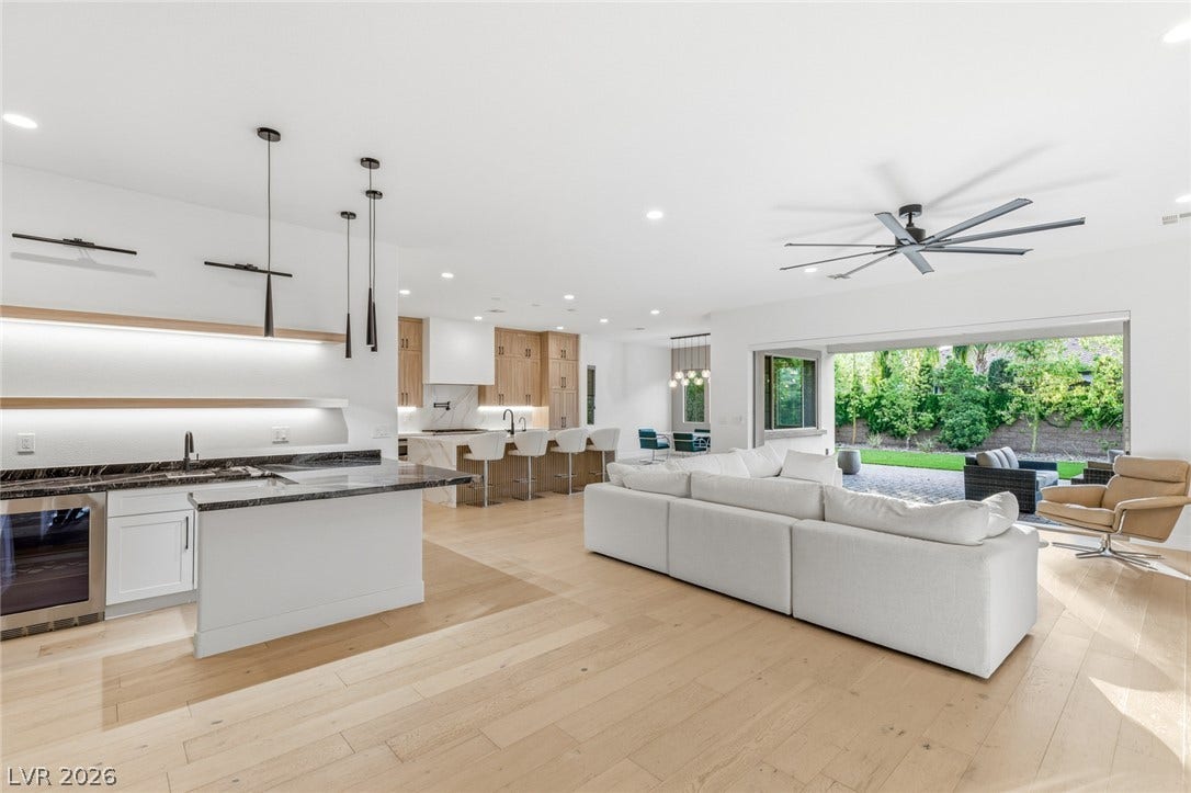 4078 San Franchesca Court, Las Vegas, NV 89141 An open concept living area features sleek hardwood flooring and a seamless transition to the outdoor patio space.