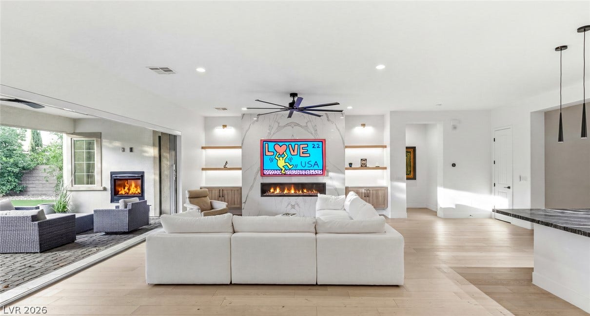 4078 San Franchesca Court, Las Vegas, NV 89141 An inviting open-concept living area flows seamlessly to an outdoor patio with a cozy fireplace.
