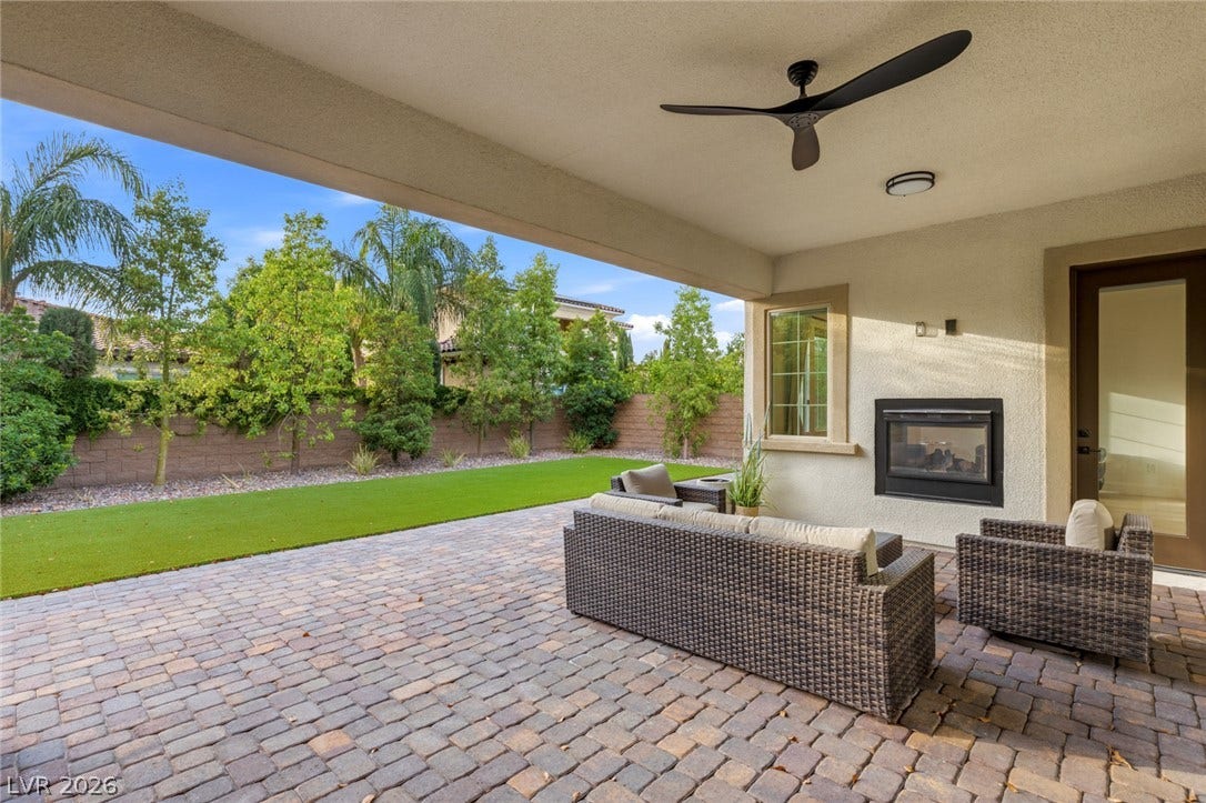 4078 San Franchesca Court, Las Vegas, NV 89141 A spacious covered patio with a fireplace creates an ideal outdoor living and entertaining space.