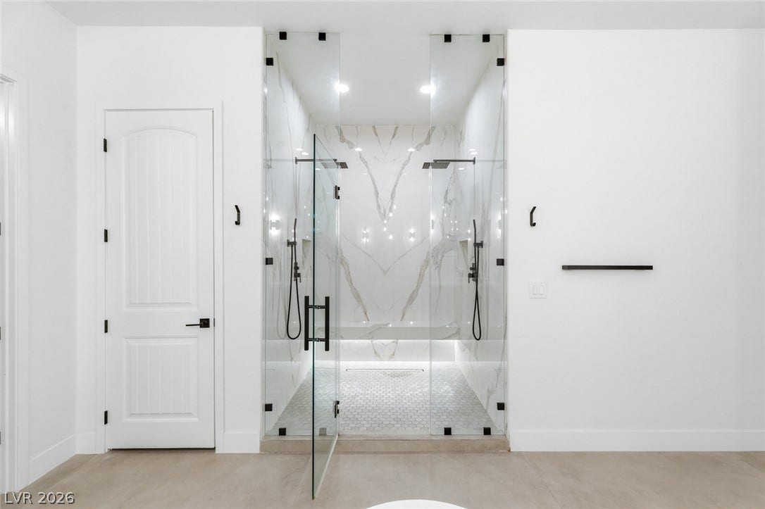 4078 San Franchesca Court, Las Vegas, NV 89141 Experience luxurious showering with this spacious, walk-in glass enclosure featuring dual shower heads and elegant marble-tiled walls.