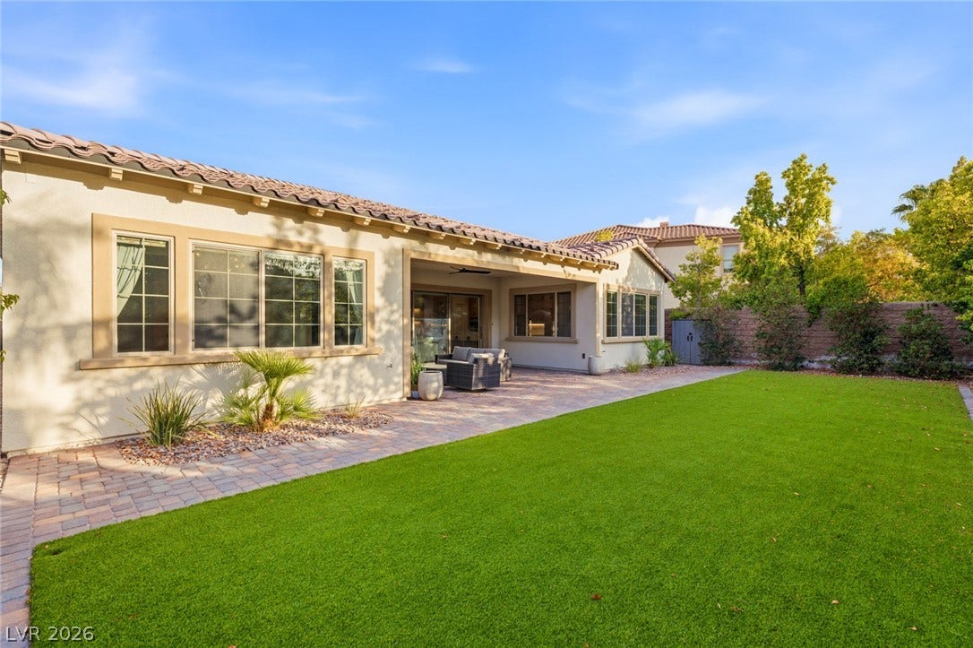 4078 San Franchesca Court, Las Vegas, NV 89141 A manicured lawn extends from a paved patio, offering ample outdoor living space.