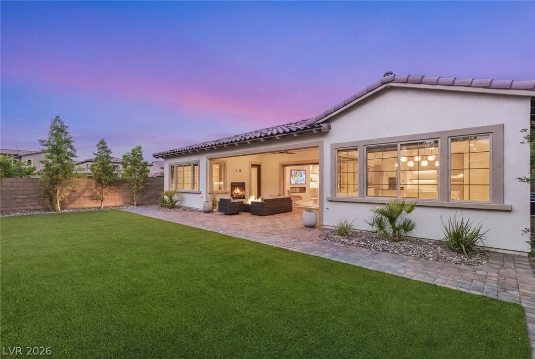 4078 San Franchesca Court, Las Vegas, NV 89141 An inviting backyard oasis offers a lush lawn and a covered patio with a cozy fire pit.