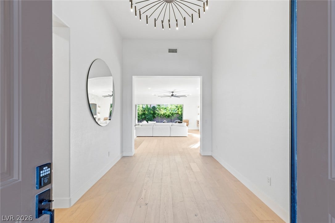 4078 San Franchesca Court, Las Vegas, NV 89141 Enter into a sun-filled foyer featuring hardwood floors and a modern light fixture, leading to an open living area.