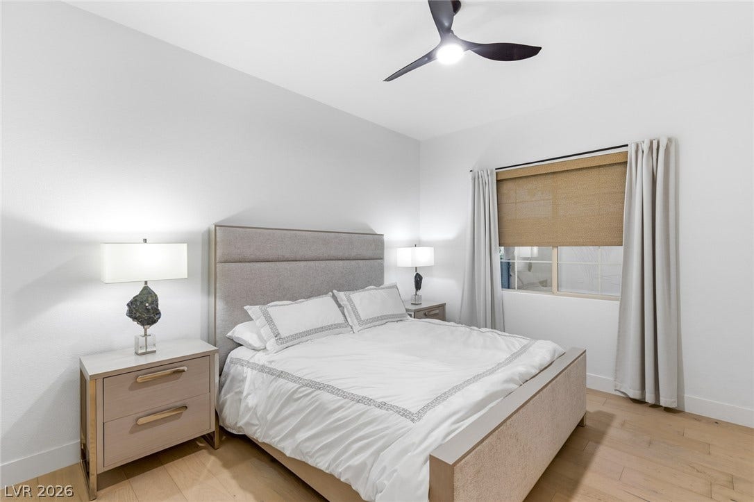 4078 San Franchesca Court, Las Vegas, NV 89141 Hardwood flooring extends throughout this well-lit bedroom featuring a modern ceiling fan and ample natural light.