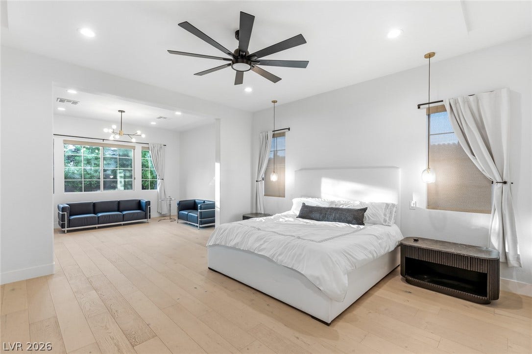 4078 San Franchesca Court, Las Vegas, NV 89141 Blonde hardwood floors extend across this bright bedroom with a dedicated sitting area.