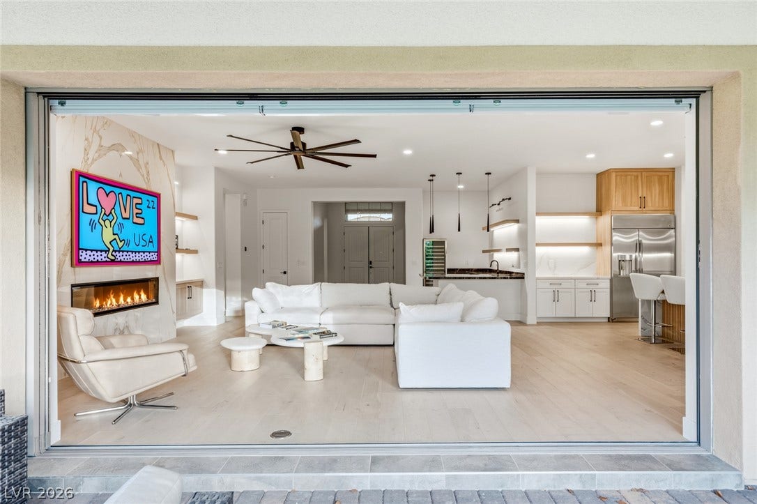 4078 San Franchesca Court, Las Vegas, NV 89141 Retractable glass doors merge the indoor living space with the outdoors, offering a seamless transition for entertaining.