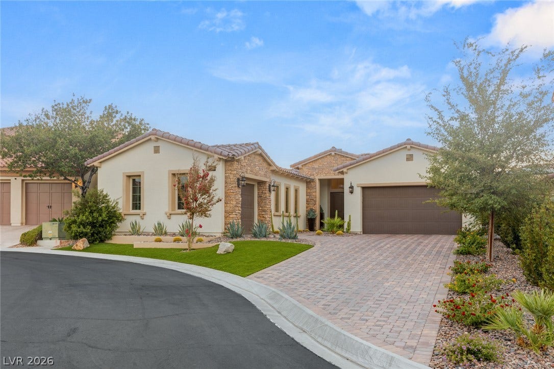 4078 San Franchesca Court, Las Vegas, NV 89141 A striking stucco and stone-accented residence welcomes with a paver driveway and meticulously landscaped front yard.