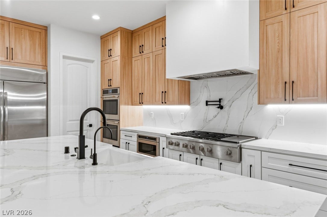 4078 San Franchesca Court, Las Vegas, NV 89141 Culinary aspirations find their home in this kitchen, featuring stainless steel appliances and an oversized island for meal preparation.