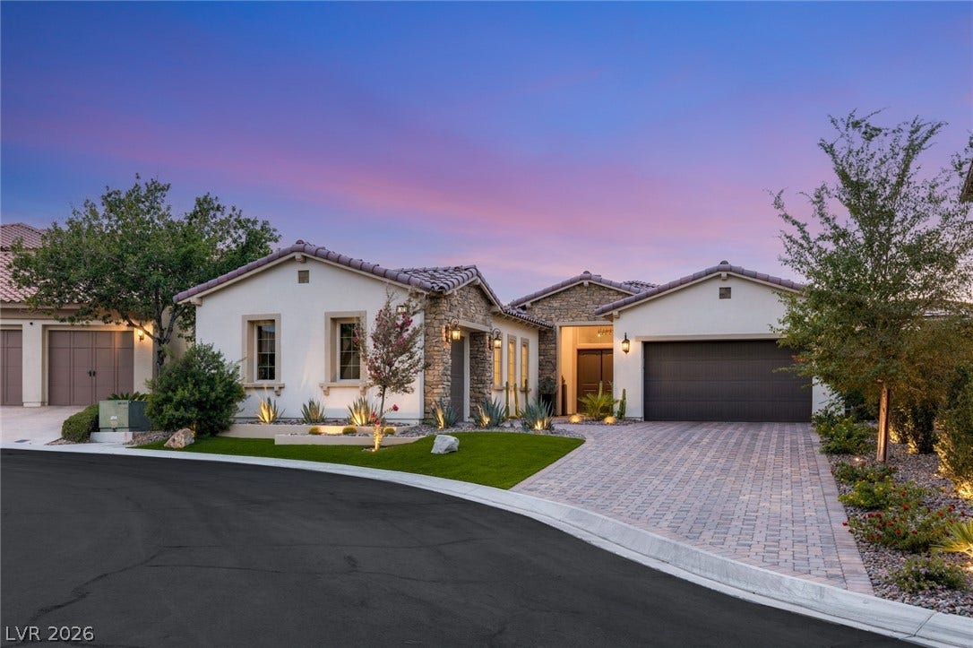 4078 San Franchesca Court, Las Vegas, NV 89141 A graceful home featuring stone and stucco exteriors, a tiled roof, and a meticulously landscaped yard with a paver driveway.