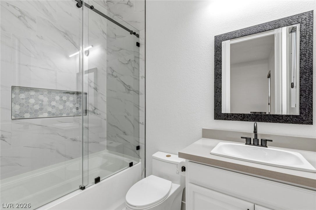 4078 San Franchesca Court, Las Vegas, NV 89141 Modern bath with walk-in shower features an elegant tiled niche for essentials.