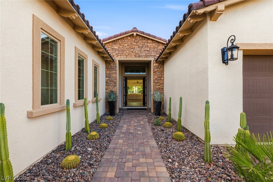 4078 San Franchesca Court, Las Vegas, NV 89141 A welcoming paver walkway leads to a grand entrance, flanked by desert-friendly landscaping.