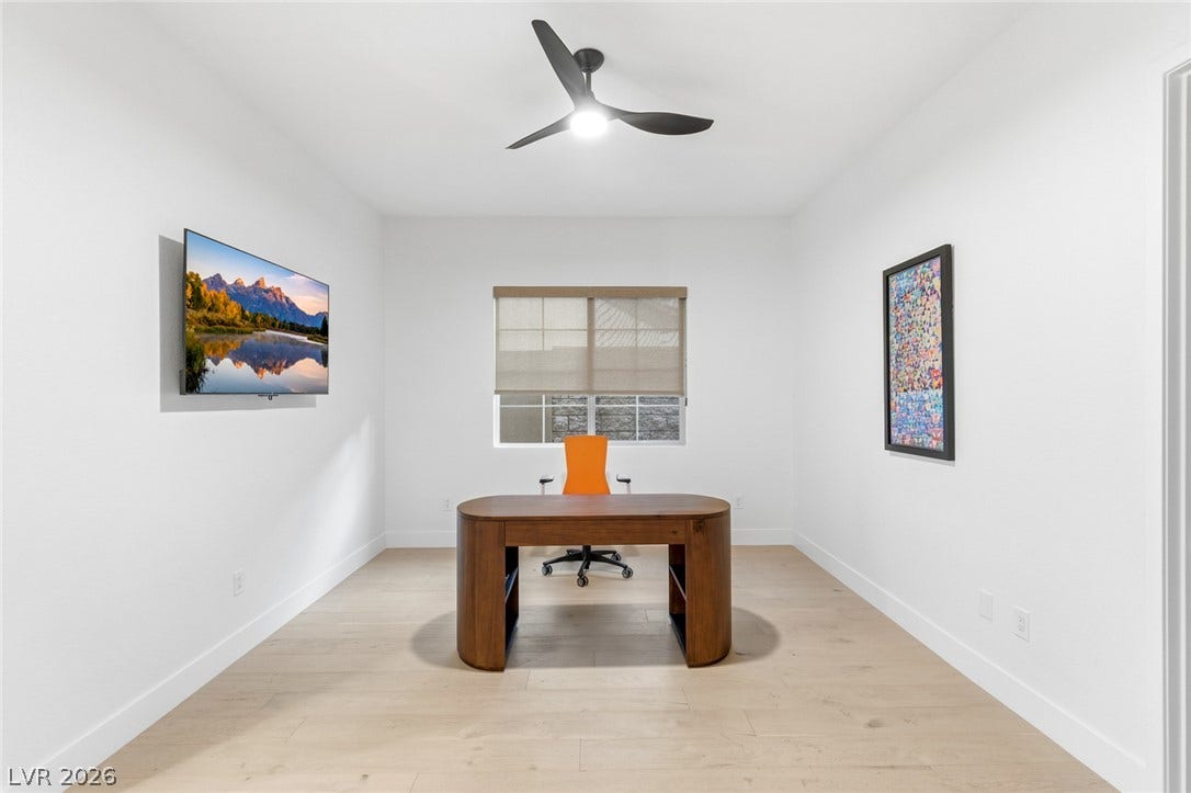 4078 San Franchesca Court, Las Vegas, NV 89141 A dedicated study space with light-toned hardwood flooring and a contemporary ceiling fan.