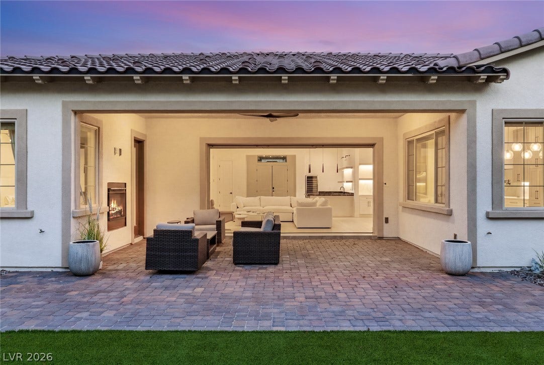 4078 San Franchesca Court, Las Vegas, NV 89141 An inviting covered patio offers a fireplace and seamlessly connects to the luminous interior living space.