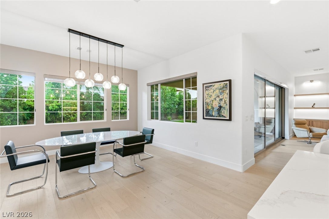 4078 San Franchesca Court, Las Vegas, NV 89141 A refined dining space bathed in natural light features sleek flooring and a contemporary linear chandelier.