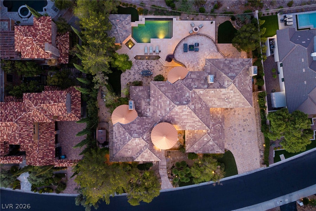 4 Ayden Drive, Henderson, NV 89052 A striking bird's-eye view reveals a sprawling estate featuring customized tile roofing and private pool.