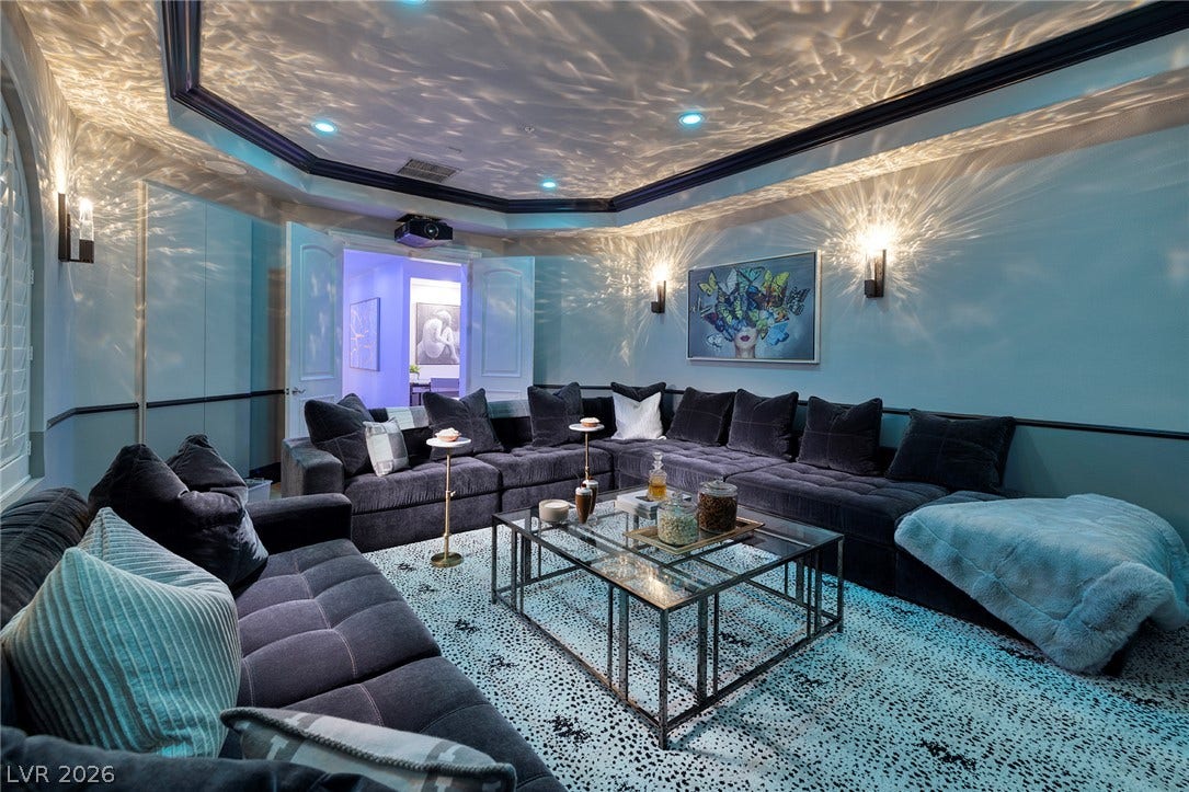4 Ayden Drive, Henderson, NV 89052 A tray ceiling and modern wall sconces enhance this comfortable media room.