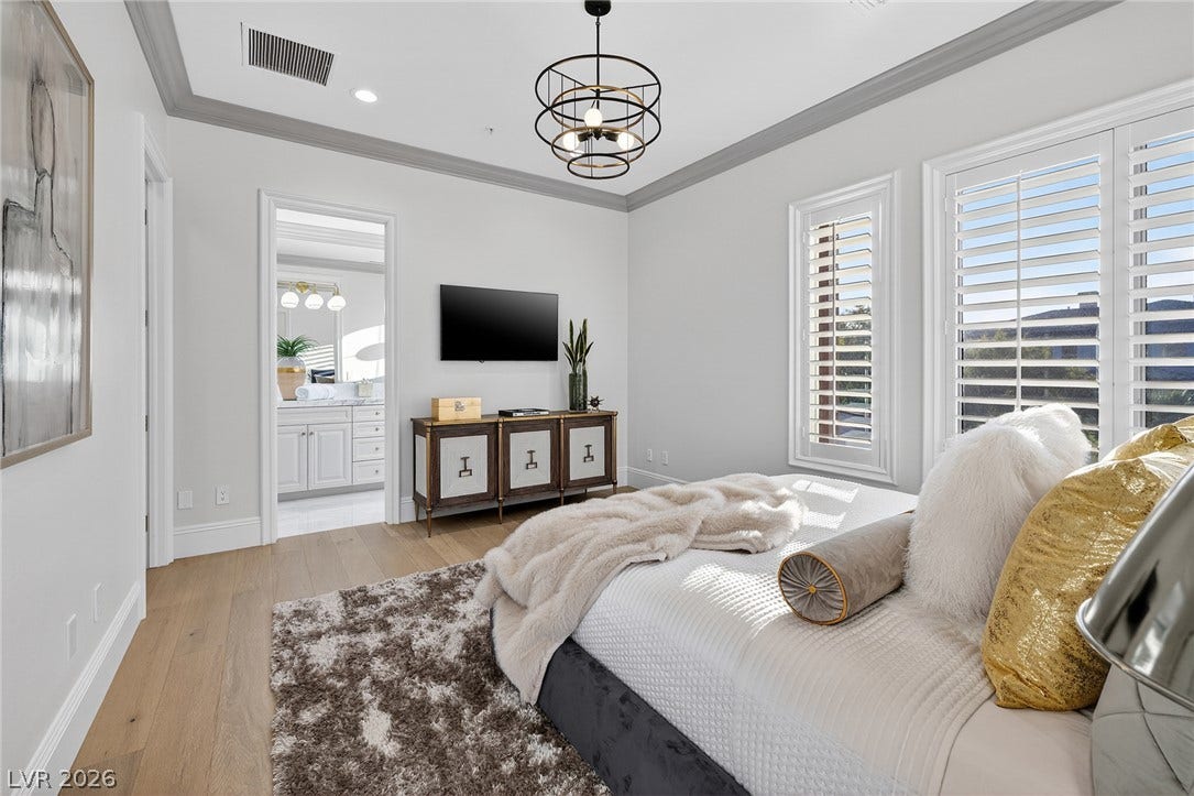 4 Ayden Drive, Henderson, NV 89052 Elegant crown molding and warm wood flooring define this peaceful bedroom retreat.