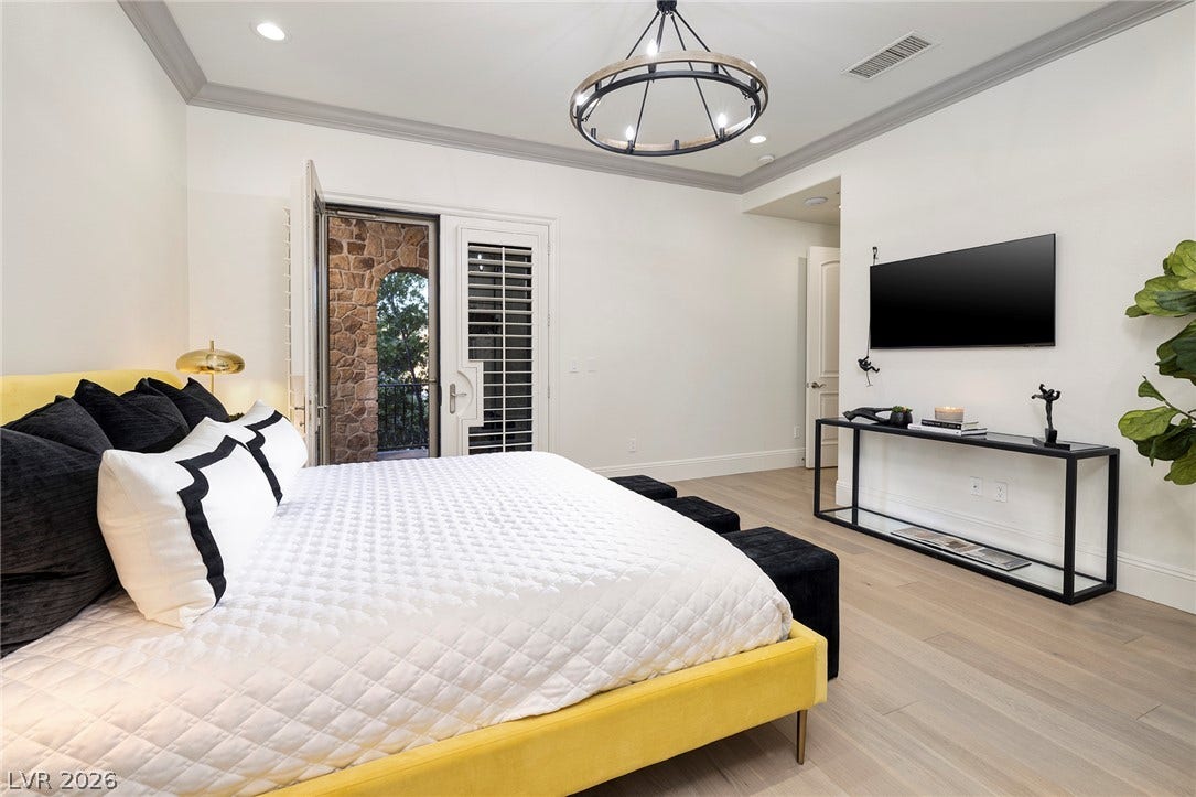 4 Ayden Drive, Henderson, NV 89052 Elegant crown molding and smooth wood floors define this tranquil primary bedroom retreat.