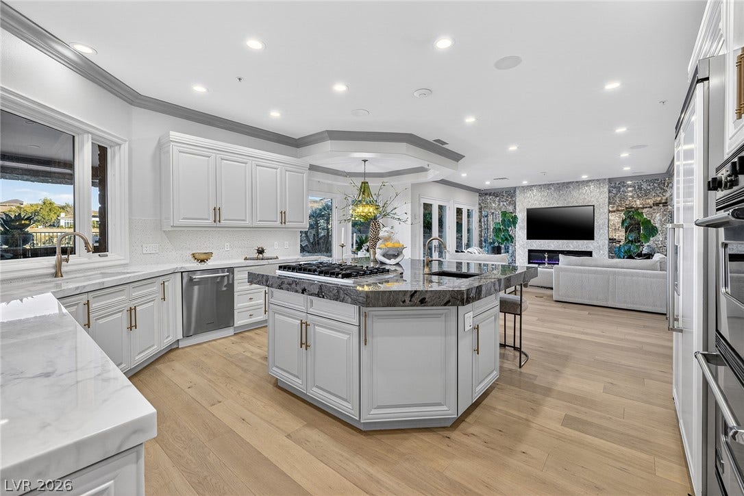 4 Ayden Drive, Henderson, NV 89052 An open kitchen anchors the main living area, accented by a central prep island.
