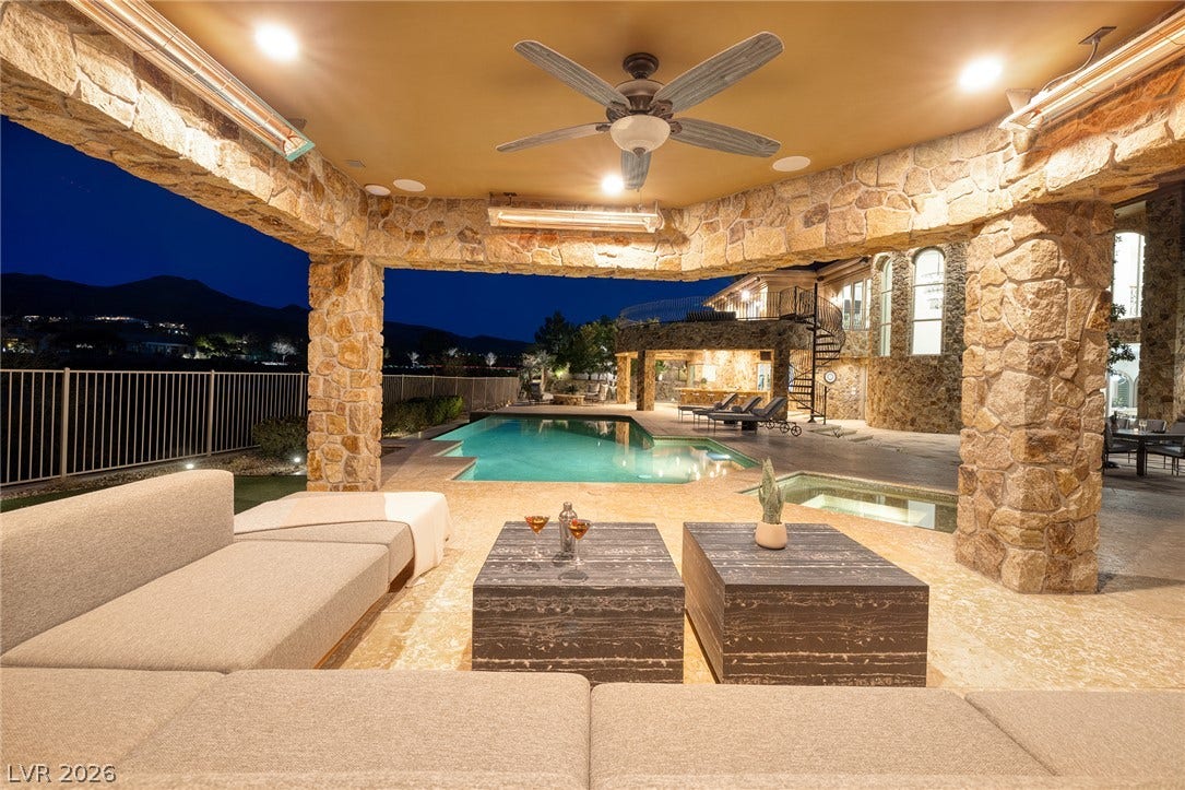 4 Ayden Drive, Henderson, NV 89052 Stone pillars frame an elegant outdoor living space overlooking a sparkling pool.