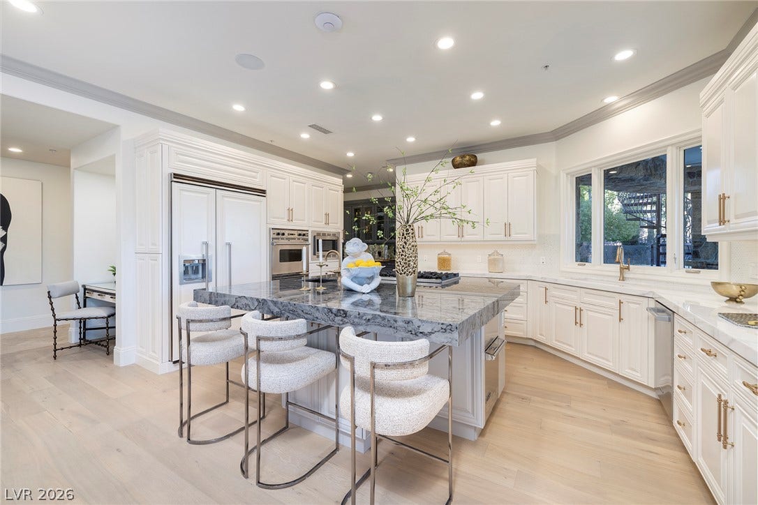 4 Ayden Drive, Henderson, NV 89052 Fine cabinetry and sleek stone countertops ground this expansive culinary space.