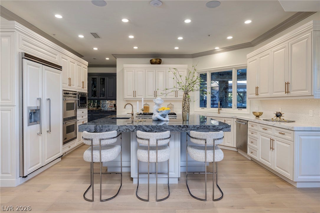 4 Ayden Drive, Henderson, NV 89052 Rich hardwood flooring complements custom cabinetry and a spacious central island in this gourmet workspace.