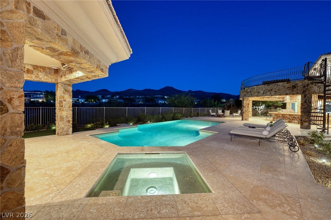 4 Ayden Drive, Henderson, NV 89052 An inviting pool and spa ensemble anchors this stone-accented outdoor terrace.