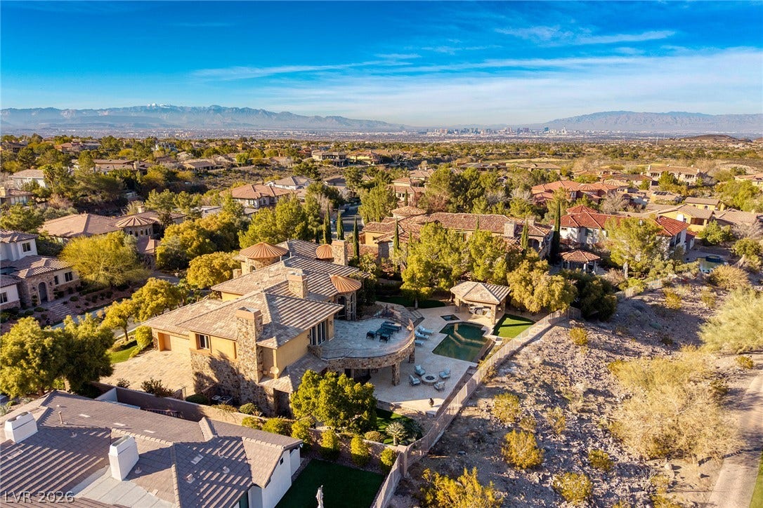 4 Ayden Drive, Henderson, NV 89052 An aerial perspective captures this impressive estate against a backdrop of distant mountains and city lights.