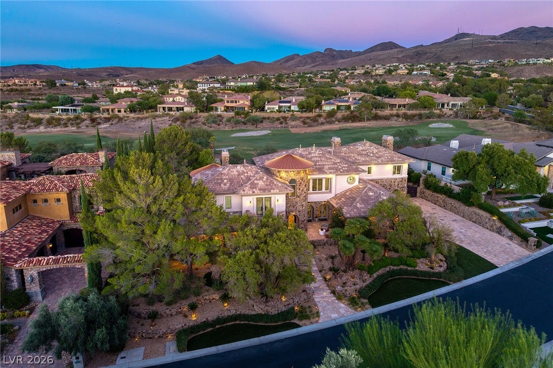 4 Ayden Drive, Henderson, NV 89052 An elegant desert estate overlooks the golf course with a mountain backdrop at twilight.