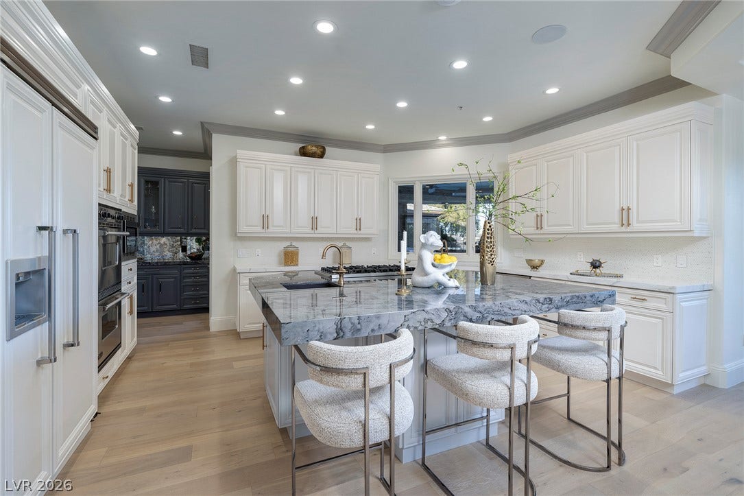 4 Ayden Drive, Henderson, NV 89052 Thick stone countertops and fine cabinetry define this light-filled culinary space with hardwood flooring.