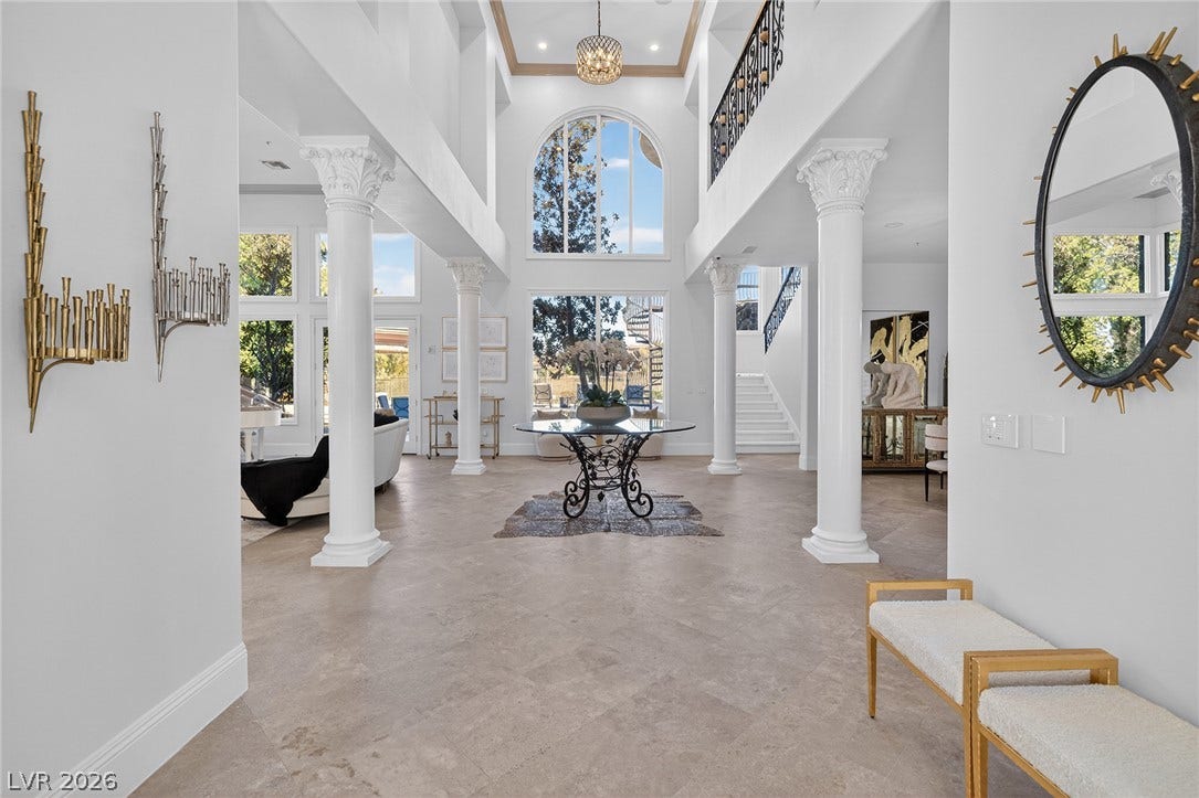 4 Ayden Drive, Henderson, NV 89052 Grand columns flank the soaring two-story entryway featuring polished tile flooring and arched windows.