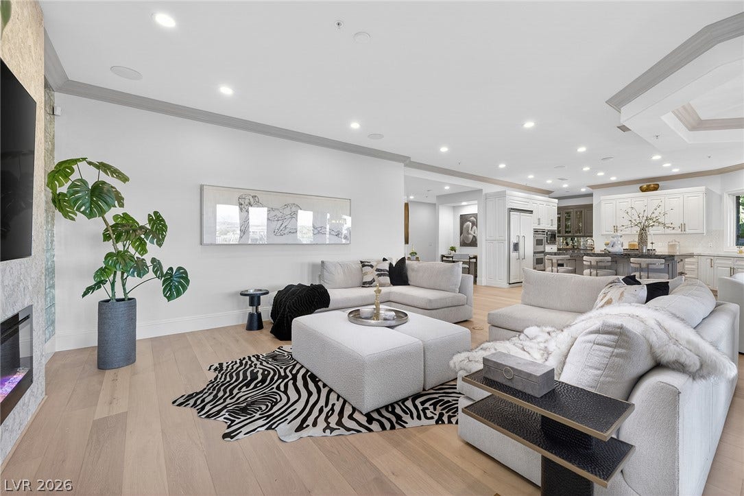 4 Ayden Drive, Henderson, NV 89052 Elegant crown molding and warm wood floors anchor this expansive open-concept living space.