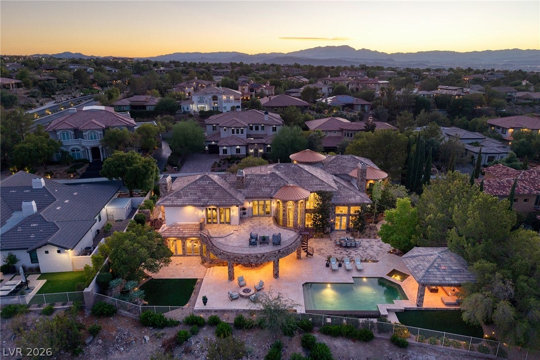 4 Ayden Drive, Henderson, NV 89052 An aerial perspective showcases the sweeping stone terrace, custom pool, and mountain backdrop.