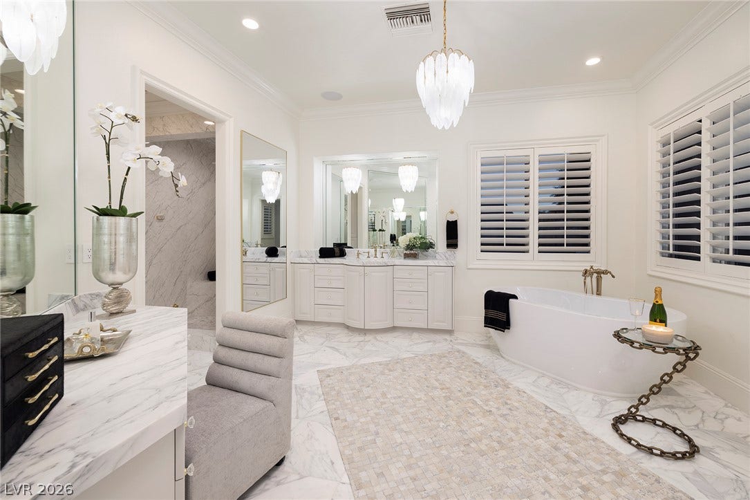 4 Ayden Drive, Henderson, NV 89052 Elegant marble flooring and a freestanding tub define this luxurious primary bathroom.