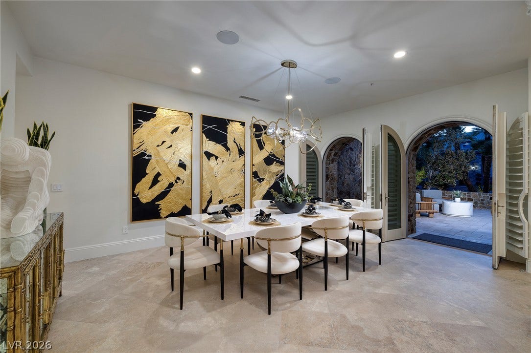 4 Ayden Drive, Henderson, NV 89052 Elegant arched doorways seamlessly connect this refined formal dining area to the outdoor patio.