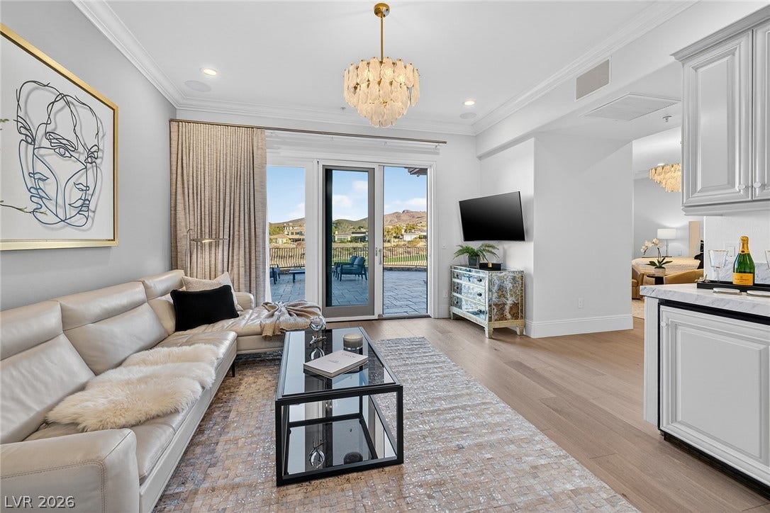4 Ayden Drive, Henderson, NV 89052 Crown molding and wide-plank wood flooring enrich this bright, open living space.