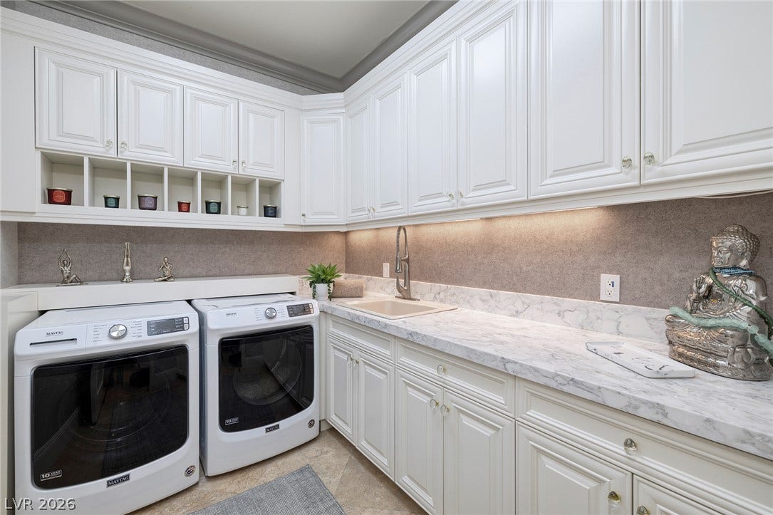 4 Ayden Drive, Henderson, NV 89052 An abundance of white cabinetry and stone-look countertops elevate this functional laundry space.