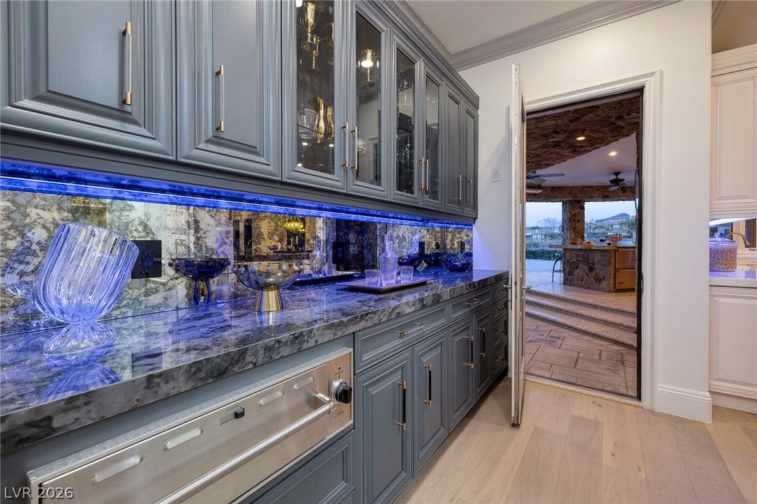 4 Ayden Drive, Henderson, NV 89052 Richly veined countertops and detailed cabinetry transition seamlessly to an inviting outdoor kitchen pavilion.