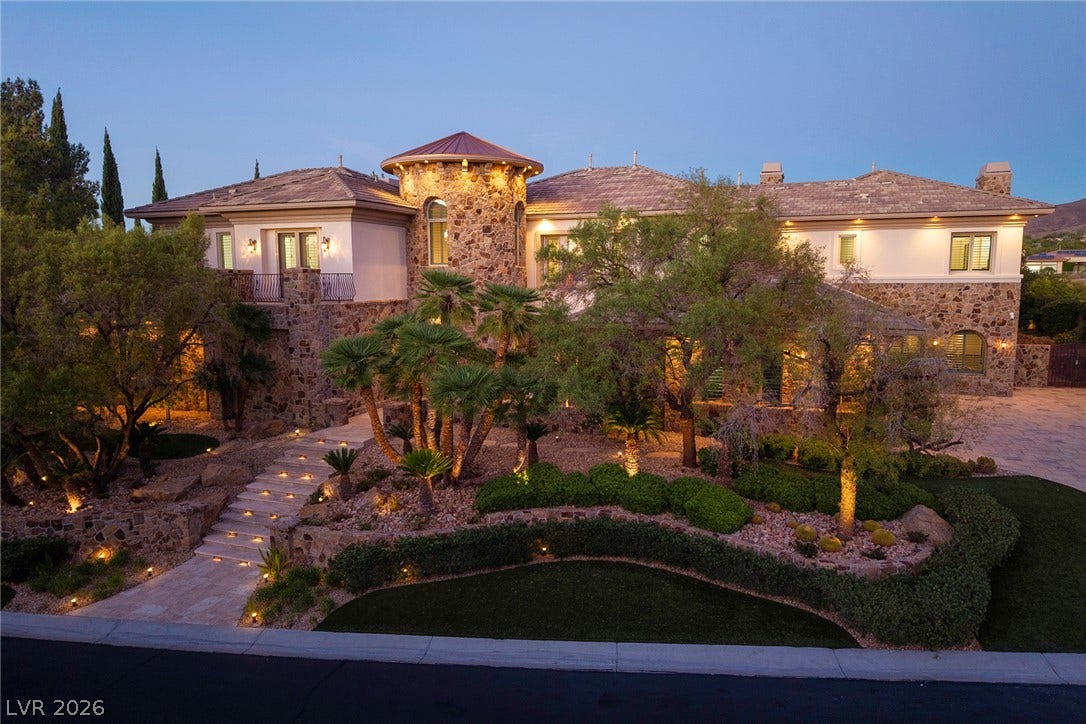 4 Ayden Drive, Henderson, NV 89052 Artfully illuminated landscaping and custom stone masonry define this grand estate's impressive facade.