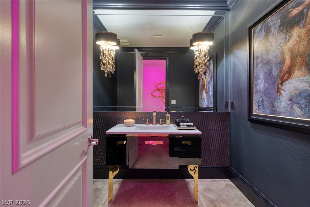 4 Ayden Drive, Henderson, NV 89052 Dramatic dark walls and a custom vanity create a memorable powder room experience.