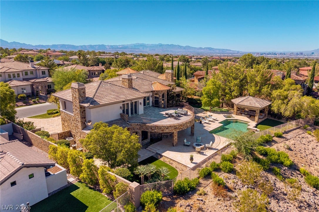 4 Ayden Drive, Henderson, NV 89052 An expansive terraced estate overlooks a private swimming pool with sweeping desert and mountain views.