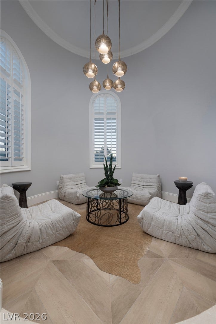 4 Ayden Drive, Henderson, NV 89052 Arched windows and elegant patterned wood flooring define this sun-filled circular sitting area.