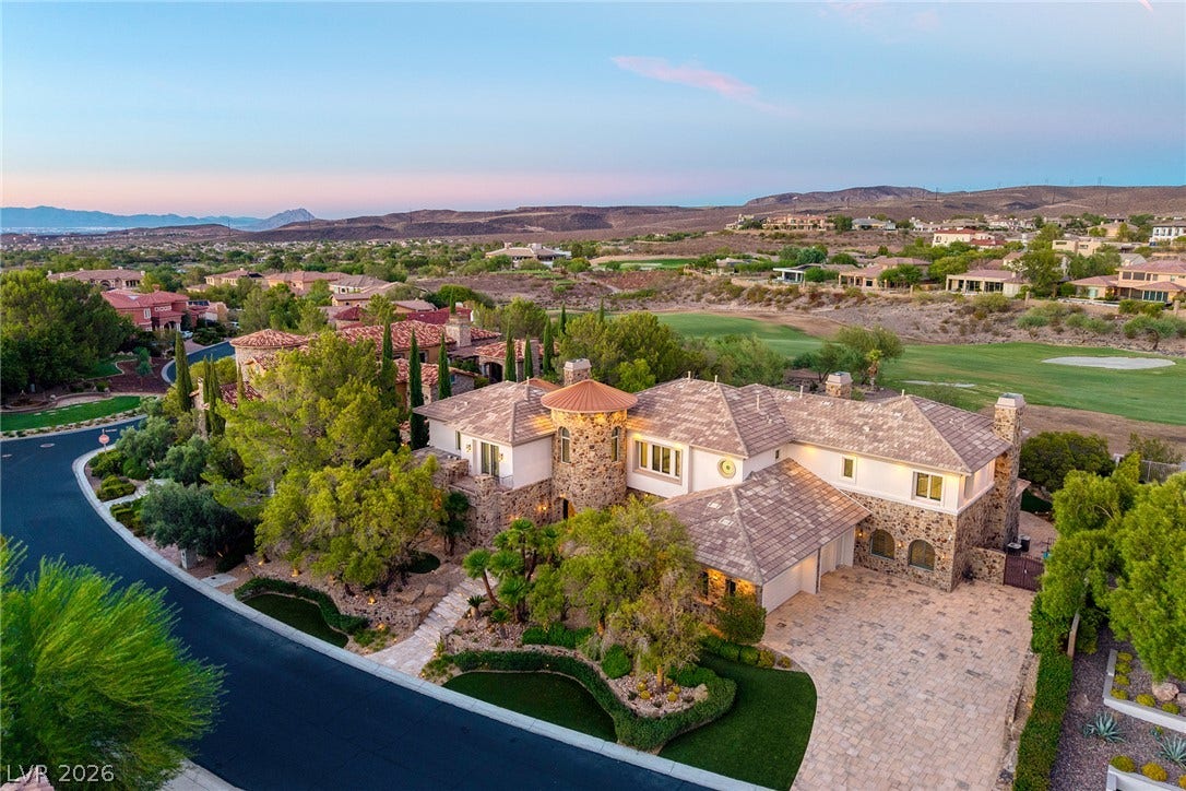 4 Ayden Drive, Henderson, NV 89052 A grand stone-accented exterior displays classic tiled roofing nestled alongside a manicured golf course.