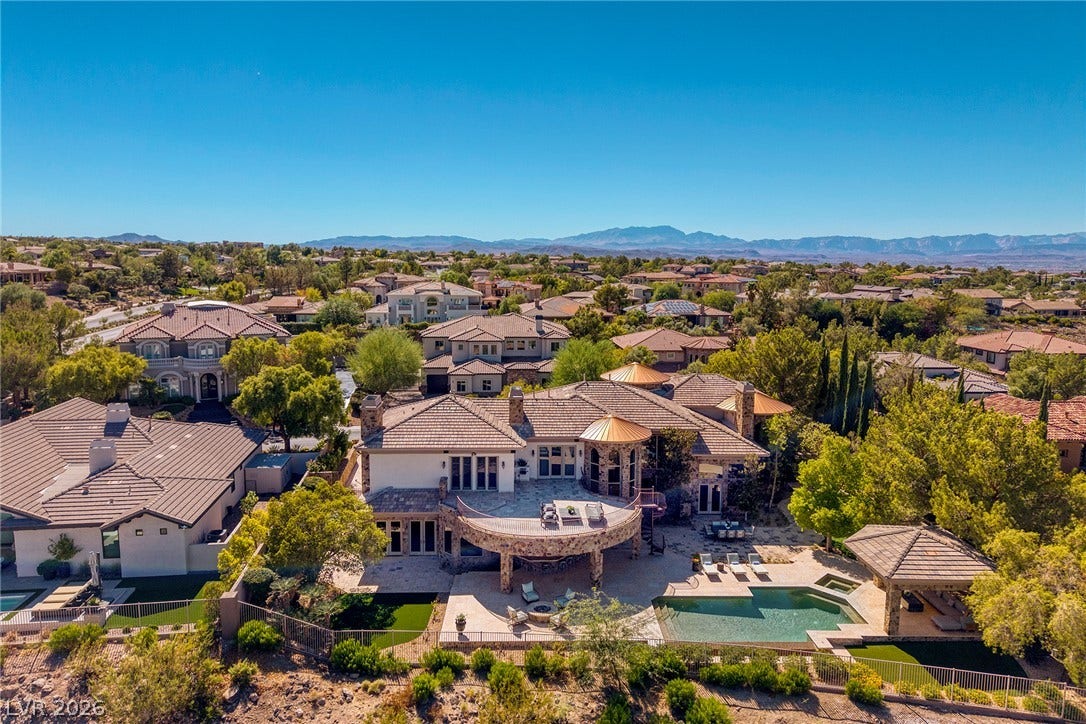 4 Ayden Drive, Henderson, NV 89052 A stone balcony and swimming pool define the backyard of this hillside estate.