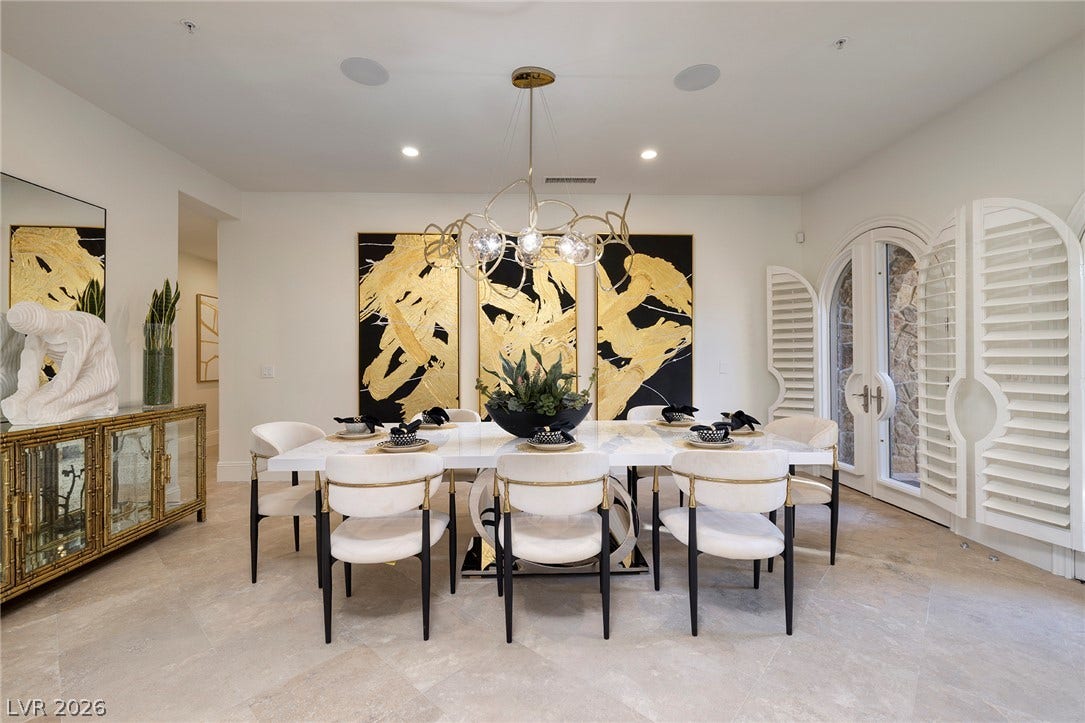 4 Ayden Drive, Henderson, NV 89052 Elegant tile flooring and arched patio doorways define this refined dining room.
