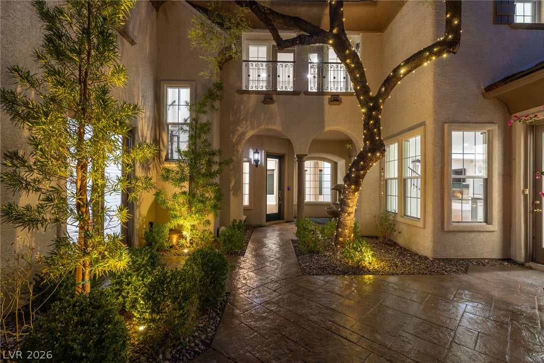 1201 Mersault Court, Las Vegas, NV 89144 An inviting gated entry courtyard is defined by stamped concrete and arched architectural details.