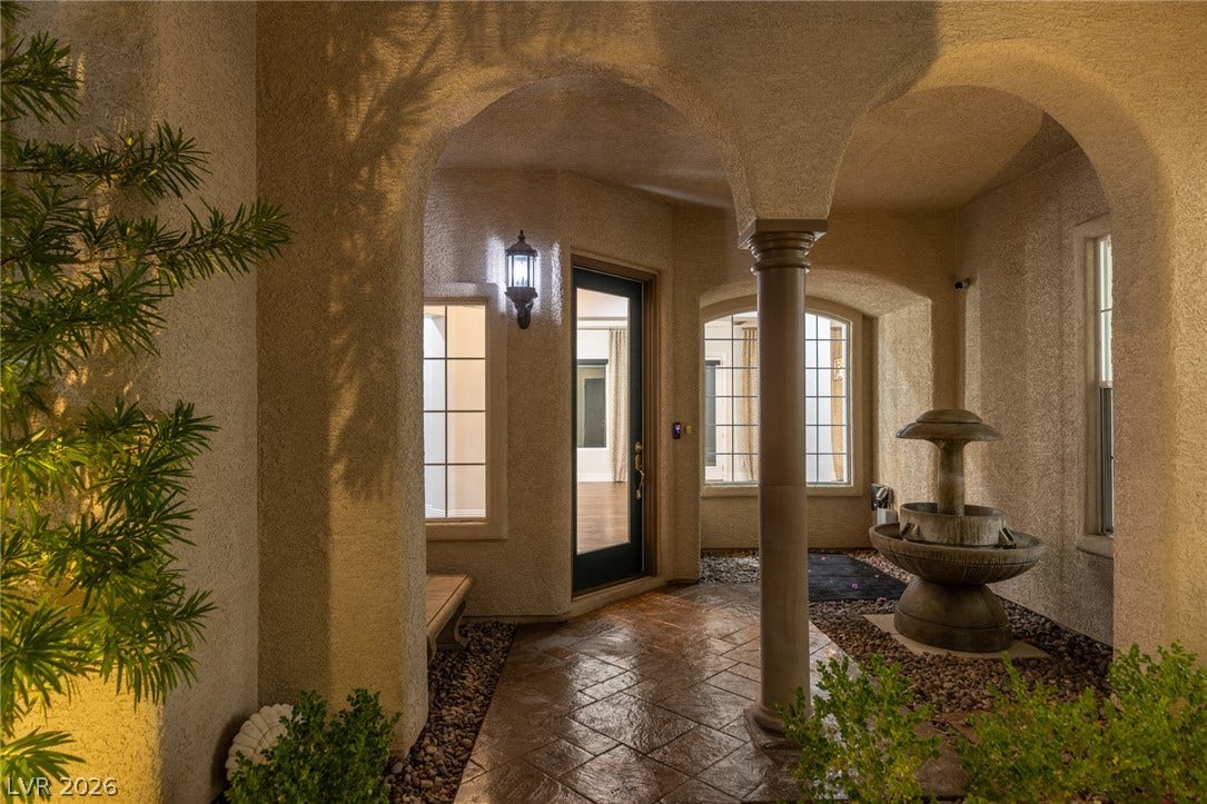 1201 Mersault Court, Las Vegas, NV 89144 Arched entryways and textured tile flooring define this welcoming covered front porch area.