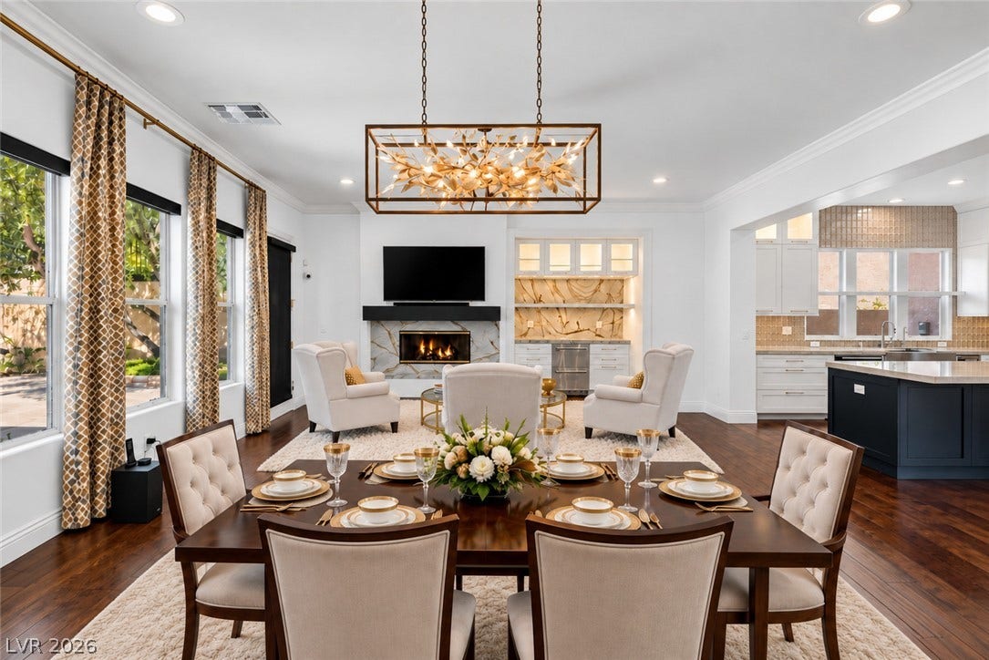 1201 Mersault Court, Las Vegas, NV 89144 Rich hardwood flooring and custom crown moldings ground this elegant open-concept dining space.