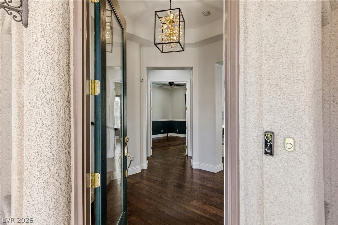 1201 Mersault Court, Las Vegas, NV 89144 An inviting entrance foyer reveals rich wood flooring and a recessed tray ceiling.