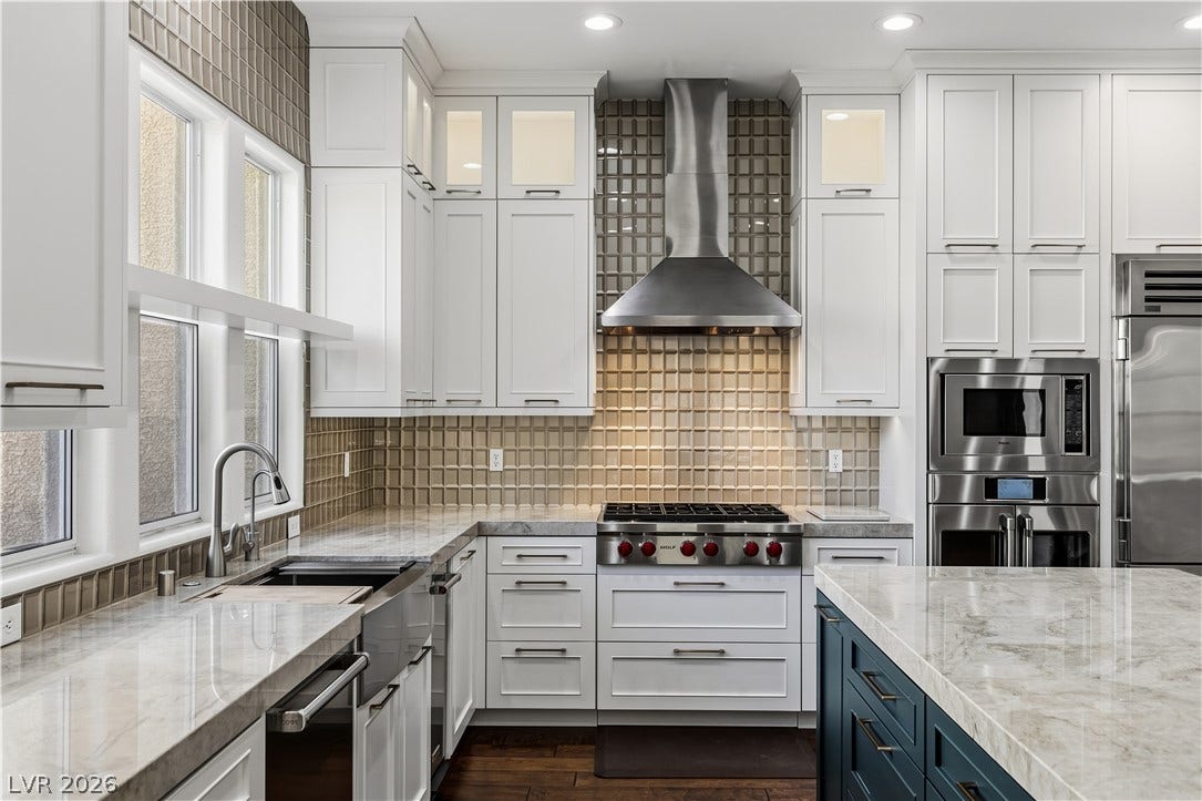 1201 Mersault Court, Las Vegas, NV 89144 Gleaming stone countertops and a professional-grade range hood anchor this masterfully crafted culinary space.